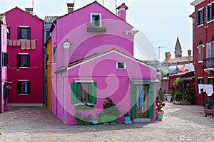 Traditional pink, bordeau and purple houses in Burano, Venice, Italy