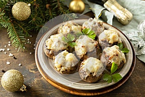 Traditional Polish Christmas dish on the table. Baked mushrooms stuffed with meat, bacon and cheese