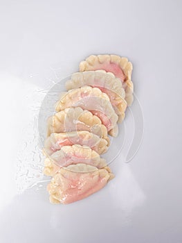 Traditional Polish pierogi with strawberries, isolated. Sweet dumplings with fruit, on white background, packshot photo.