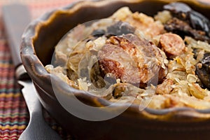 Traditional polish sauerkraut (bigos) with mushrooms and plums