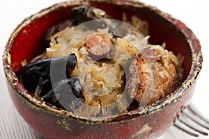 Traditional polish sauerkraut (bigos) with mushrooms and plums