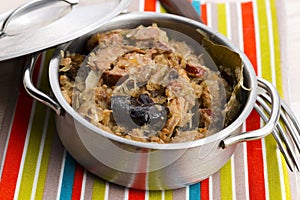 Traditional polish sauerkraut (bigos) with mushrooms and plums