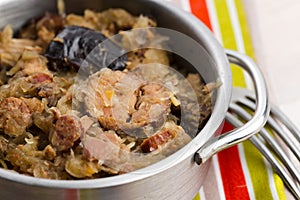 Traditional polish sauerkraut (bigos) with mushrooms and plums