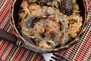 Traditional polish sauerkraut (bigos) with mushrooms and plums