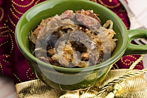 Traditional polish sauerkraut (bigos) with mushrooms and plums