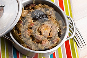 Traditional polish sauerkraut (bigos) with mushrooms and plums