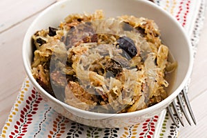 Traditional polish sauerkraut (bigos) with mushrooms and plums
