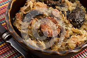 Traditional polish sauerkraut (bigos) with mushrooms and plums