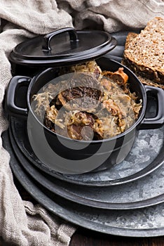 Traditional polish sauerkraut bigos with mushrooms and plums for christmas