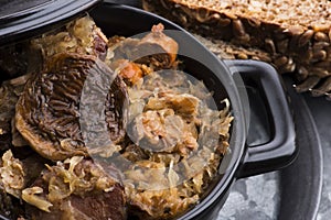 Traditional polish sauerkraut bigos with mushrooms and plums for christmas