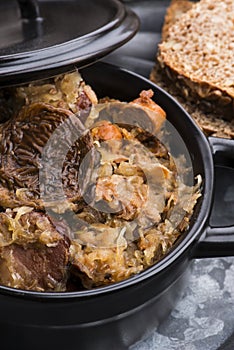 Traditional polish sauerkraut bigos with mushrooms and plums for christmas