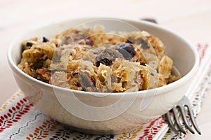 Traditional polish sauerkraut (bigos) with mushrooms and plums