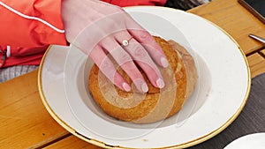 Traditional Polish soup called zur or white borscht into bread bowl and woman hand close up