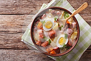 Traditional Polish soup Zurek in a bowl. Horizontal top view