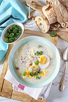 Traditional polish soup Zurek. Sour soup with sausage, potatoes and eggs