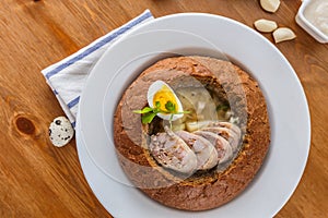 Traditional polish zurek with sausage, egg in bread