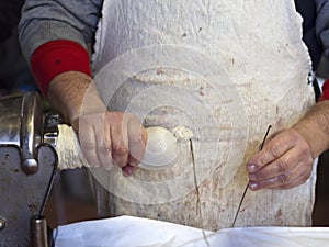 Traditional pork salami making using pig intestines for skin. Rustic, rural Italy. Genuine farm production.