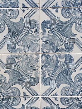 Traditional portugese tiling with floral ornate. Vintage ceramic tiles of faded blue colour on the streets of Lagos, Algarve coast