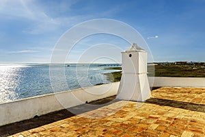 Traditional Portuguese chimney with landscape of Ria Formosa Natural Park, Algarve, Portugal