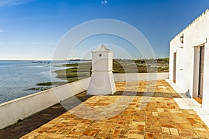 Traditional Portuguese chimney with landscape of Ria Formosa Natural Park, Algarve, Portugal