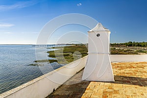 Traditional Portuguese chimney with landscape of Ria Formosa Natural Park, Algarve, Portugal