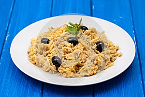 Traditional portuguese dish bacalhau a bras on white plate on wooden background