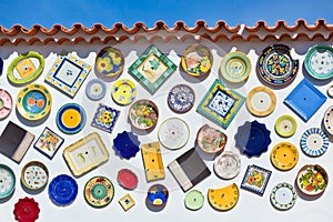 Traditional portuguese pottery plates on a wall in Algarve