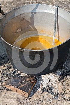 Traditional pot over fire and steam coming from it, authentic medieval cuisine