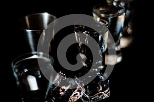 Traditional pure vodka in glasses on a black background, chilled