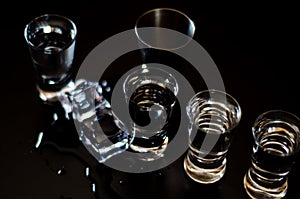 Traditional pure vodka in glasses on a black background, chilled