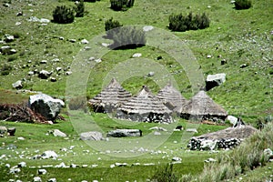 Traditional quechua village houses with conic straw roof