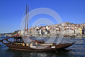 Traditional rabelo boats, Porto city skyline, Douro river and and Dom Luis or Luiz iron bridge. Porto