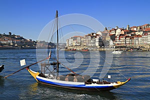 Traditional rabelo boats, Porto city skyline, Douro river and and Dom Luis or Luiz iron bridge. Porto