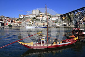 Traditional rabelo boats, Porto city skyline, Douro river and and Dom Luis or Luiz iron bridge. Porto