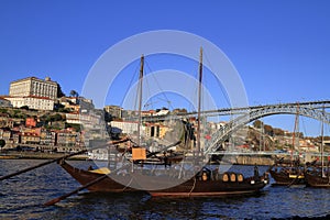 Traditional rabelo boats, Porto city skyline, Douro river and and Dom Luis or Luiz iron bridge. Porto