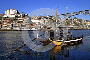 Traditional rabelo boats, Porto city skyline, Douro river and and Dom Luis or Luiz iron bridge. Porto