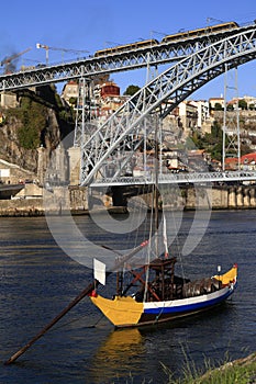 Traditional rabelo boats, Porto city skyline, Douro river and and Dom Luis or Luiz iron bridge. Porto