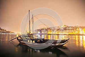 Traditional rabelo boats on Porto river at nigh