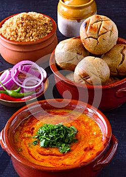 Indian meal in terracotta pots -Dal baati churma photo