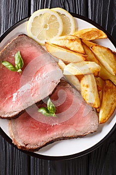 Traditional recipe of beef steak is served with roasted potatoes