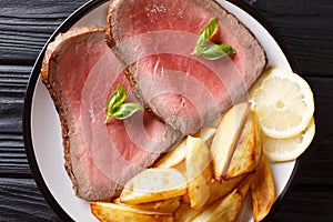 Traditional recipe of beef steak is served with roasted potatoes