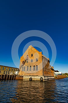 Traditional red brick building by the canal in Copenhagen, Denmark