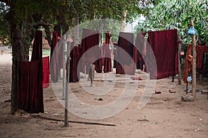 Traditional red buddhist robes hang drying