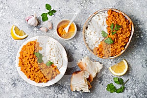 Traditional red lentil Dal. Indian Dhal spicy curry in bowl with flat bread and spices. Top view, overhead.