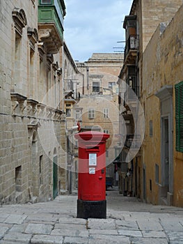 Traditional Red Post Box in Narrow Street in Malta
