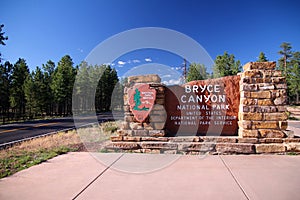 The traditional red rocks and wood sign at the entrance of Bryce Canyon National Park