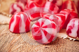 Traditional red and white candies on wooden backgrou