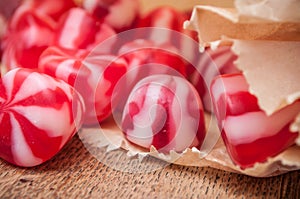 Traditional red and white candies on wooden backgrou