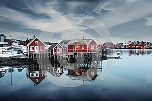Traditional red wooden house at waterfront in fishing village on winter at Reine town, Lofoten Islands