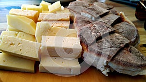 Traditional regional Azorean cheese and flatbread sitting on a wooden board